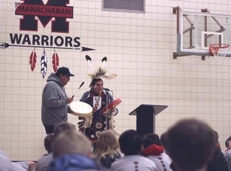Shyles Smalleyes and Daryl Kootenay drum during the unveiling of Manachaban School&#8217;s new logo.