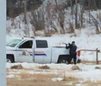 RCMP surround a house where two individuals had barricaded themselves after police attempted to serve an arrest warrant.