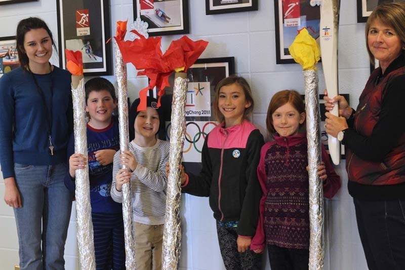 Students Ben Roper, Mathias Dubyk, Avery Bell and Amee Lindquist show off their Olympic torches with teachers Stephanie Foley (left) and Melonee Rose (right).