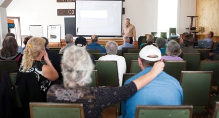 Former petroleum engineer Dan Thomas speaks at a community meeting on fracking Sept. 15 at Weedon Pioneer Hall.