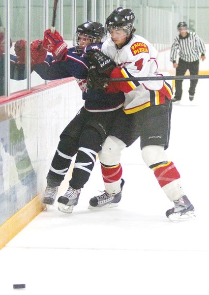 Cochrane Generals prospect Kayin Pauls (left) and Airdrie Thunder&#8217;s Ashton Sheen battle along the boards in Heritage Junior Hockey League exhibition play Sept. 16 at