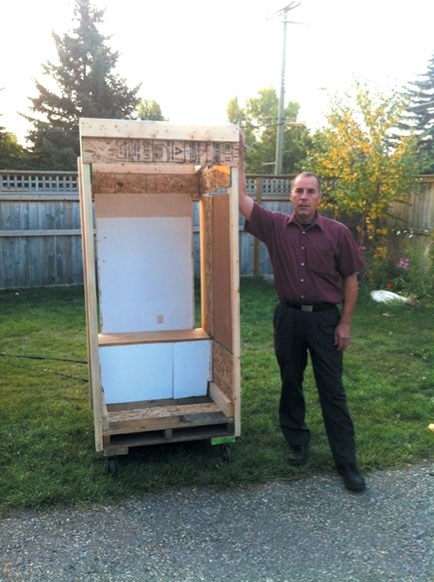 Darcy Shipton of Stadium Nissan in Calgary proudly displays the shell for what he hopes will be the winning outhouse in the 2012 Cochrane Outhouse Races Sept. 29; an