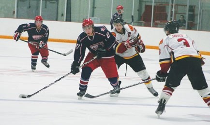 Cochrane Generals forward Cole Widdifield works his way through Airdrie Thunder&#8217;s Alex Hustad and Ryan Gould (right) as Alex Colborne (left) hustles up the ice to