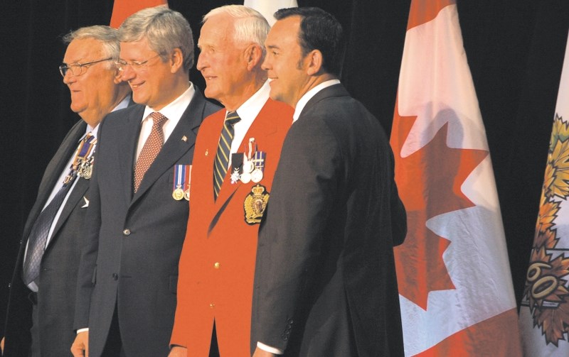 Bob Head, red blazer, receives his Queen&#8217;s Diamond Jubilee medal from Prime Minister Stephen Harper, second from left, Lt. Gov. of Alberta, Donald Ethell, far left, and 