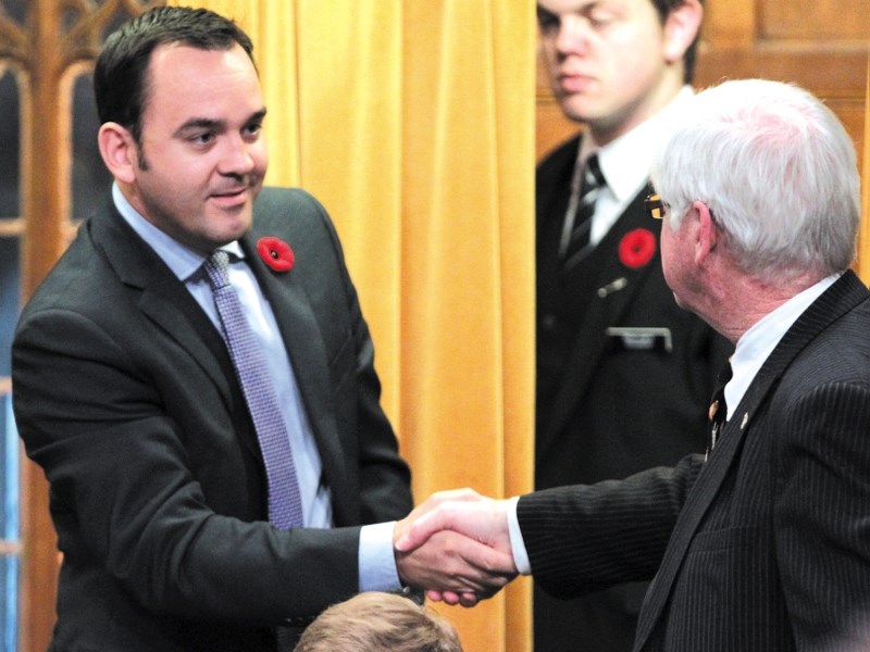 Wild Rose MP Blake Richards, left, is congratulated by fellow Conservative MP David Tilson after the passing of Richards&#8217; Bill C-309.