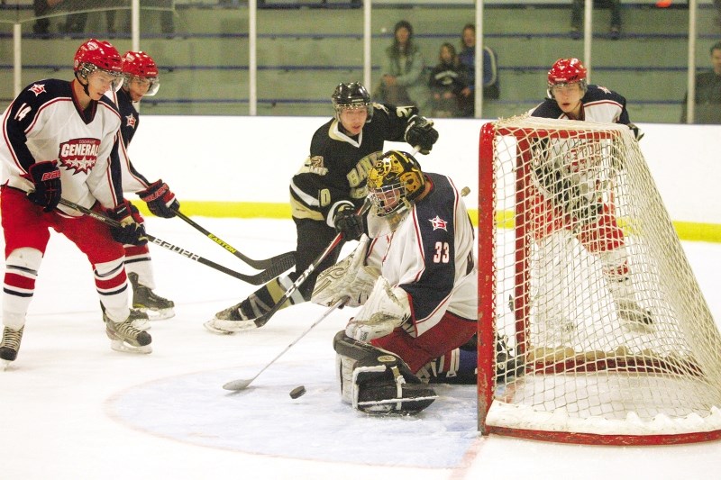 Generals goalie Brady Markham kicks out a shot from Banff Bears forward Michael Harbich in Heritage Junior Hockey League play Nov. 3 in Banff. The Generals won 9-4.