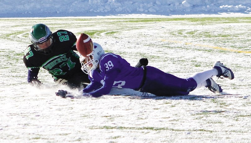 Lightning defensive back Evan Petriew knocks a pass away from Phoenix receiver Owen Ferguson.