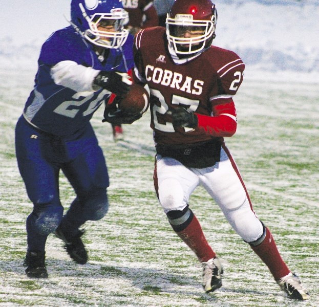 Cobras receiver Nik Noseworthy puts the moves on Vikings defensive back Zach Lutz in the game won 32-16 by the Cobras, who meet the Churchill Bulldogs of Lethbridge in a