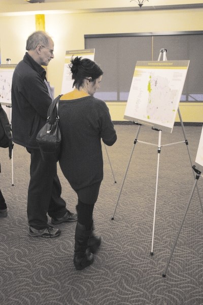 Bob McMechan and Jennifer Janzen look over plans for a land-use framework for the South Saskatchewan region.