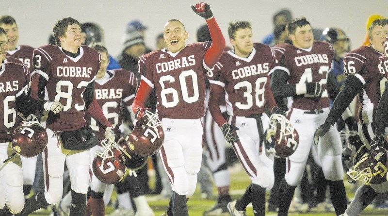 Cochrane High School Cobras football players (from left) Zach Deagle, Mike Quillian, Travis Colleaux and Aiden Smith celebrate their provincial high school Tier 3 football