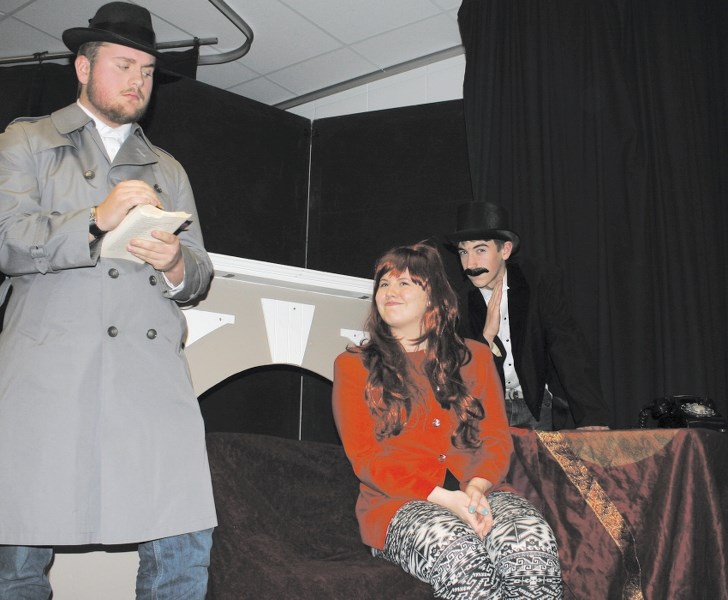 Bow Valley High School Grade 12 students James Crabtree, left, playing Red, and Becki Masterman playing Holly Wreath, along with Grade 10 student Ty Duke as Humbug, rehearse