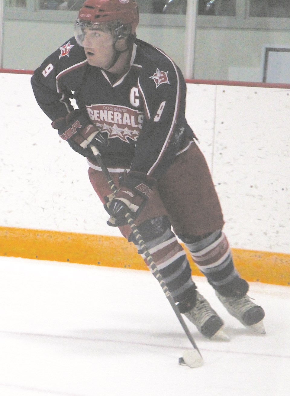 Cochrane Generals forward Jason Labelle looks for someone in scoring position from behind the Strathmore Wheatland Kings net in Heritage Junior Hockey League play Nov. 30 at