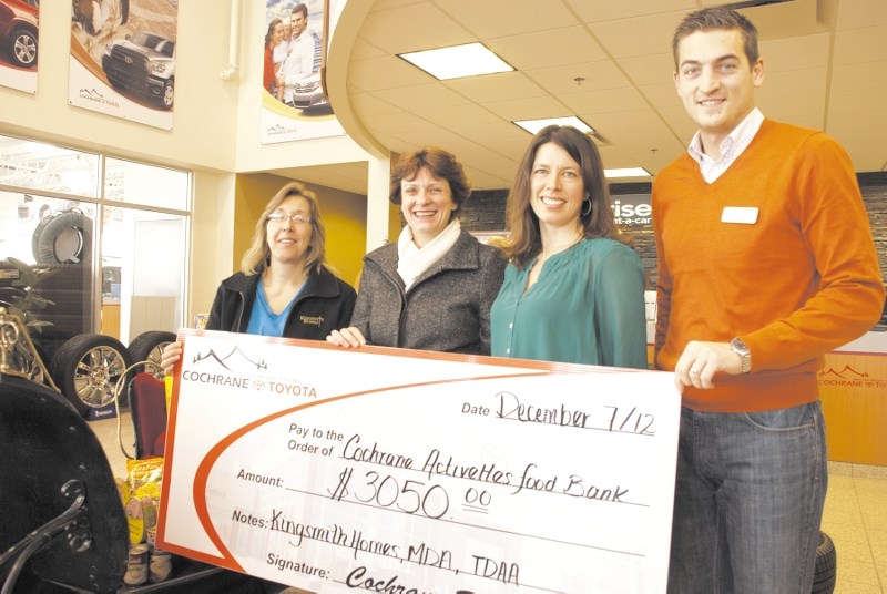 From left, Karen Kingsmith and Helen Parnell of the Activettes accept a cheque from Patti Cameron and Ryan Baum of Cochrane Toyota. The local dealership, in conjunction with