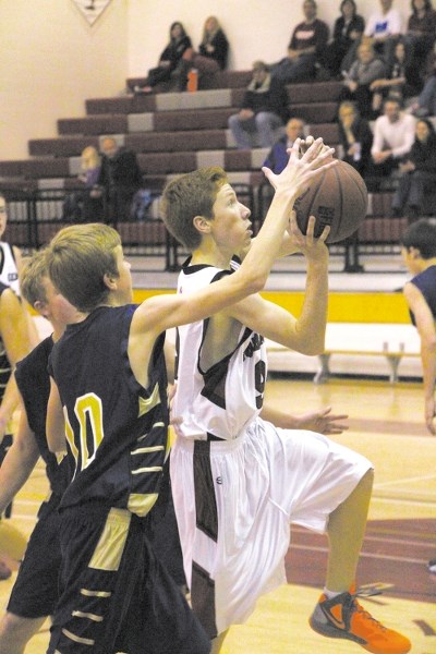 Cochrane High School Cobras&#8217; Daniel Cridland drives for the rim as Bow Valley High School Bobcats&#8217; Michael Davies tries to get a hand on the ball in Rocky View