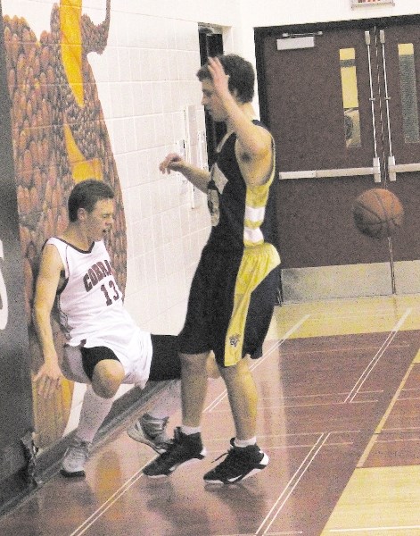 Cochrane High School Cobras&#8217; Chace Nielson slams into the wall in front of Bow Valley High School Bobcats&#8217; Liam Smith in Rocky View Sports Association senior