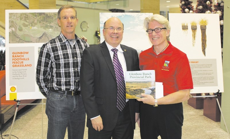 GRPPF CEO Andy Crooks, right, and director Tim Harvie, left, present Shell vice-president Louis Auger with a copy of the book, Glenbow Ranch Provincial Park.