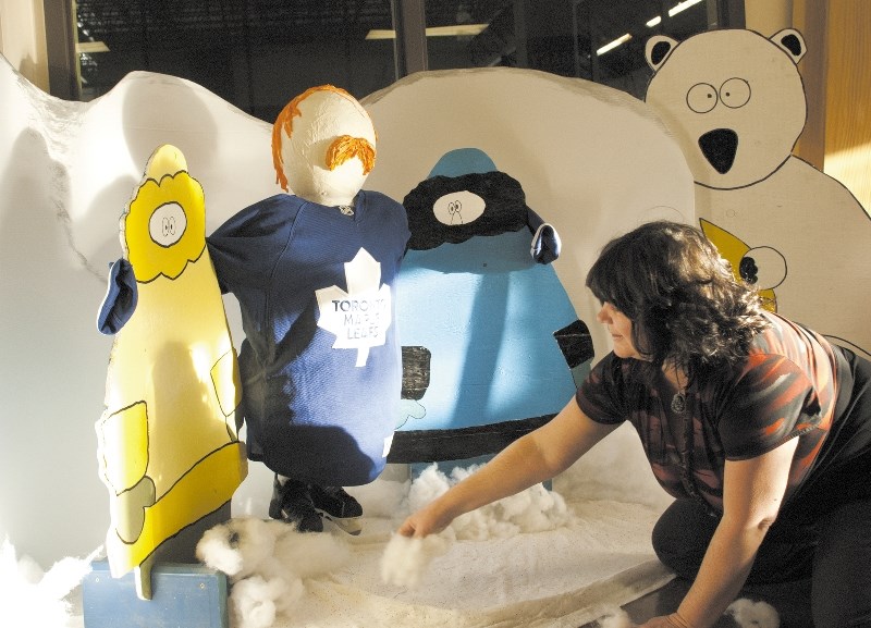 Marlise Rockwell sets up a display promoting the upcoming ATCO Gas Cochrane WinterFest. Rockwell created 20 snowmen for the winter event, which runs Jan. 25 and 26 at the