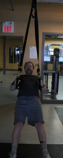 Art Norris tries out the TRX suspension training device.