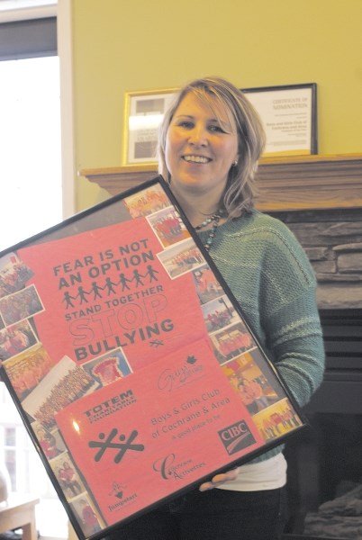 Karri Berg, community outreach and community awareness and prevention of violence coordinator for the Boys and Girls Club of Cochrane and Area, shows off memorabilia from