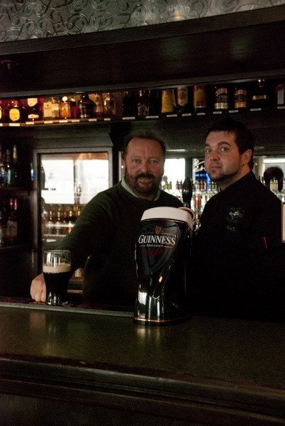 Killarney&#8217;s Irish Pub owner Michael Pyne, left, poses with head chef Dave Bennett behind the bar of the Airdrie pub.