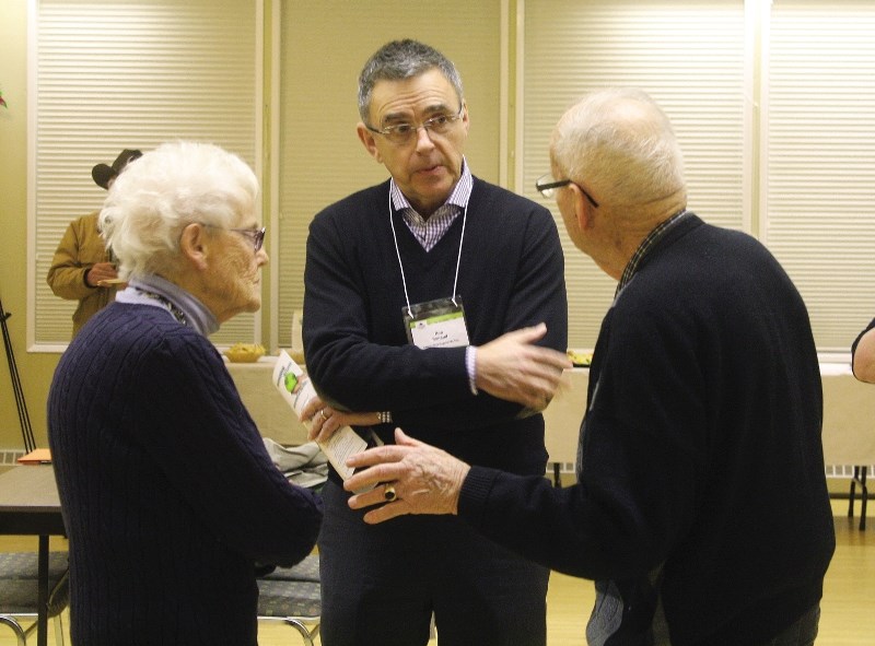 Ron Renaud, developer for Rencour Developments Inc. and Bingham Crossing, speaks with residents during an open house held Jan. 15 at the Springbank Heritage Club.