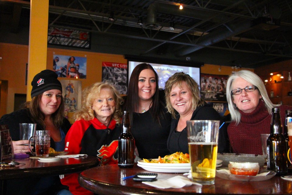 Cochrane hockey fans (from left) Sally Curnow, Sharon Nolen, server Kelan Kovacs, Diane Snoxell and Jacquie McCormack convene at Ducks on the Roof sports bar for the first