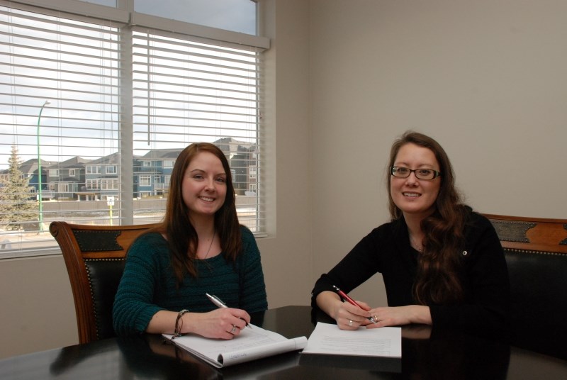 Nicole Rumley (left) and Natalya Nicholson agree that the best way to pay back a student loan is to continue to live on a student budget.