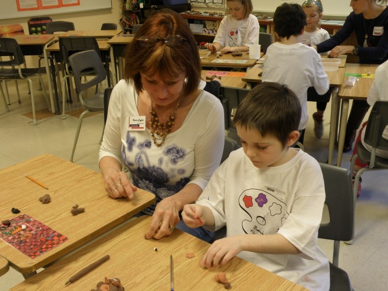 Local artist Karin Taylor helped Grade 3 student Jason LaPlante make a hippo pen during the Amazing Animals clay workshop at Banded Peak School&#8217;s Fine Arts Day on Jan.