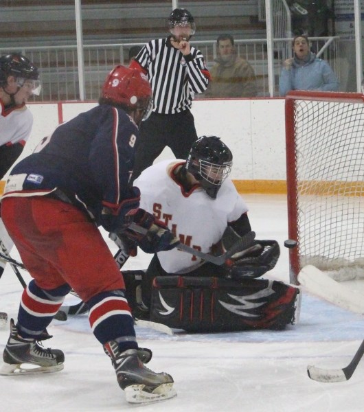 Cochrane Generals forward Jason Labelle flips the puck past Ponoka Stampeders netminder Eli Falls in Heritage Junior Hockey League play Feb. 2 at Spray Lake Sawmills Family