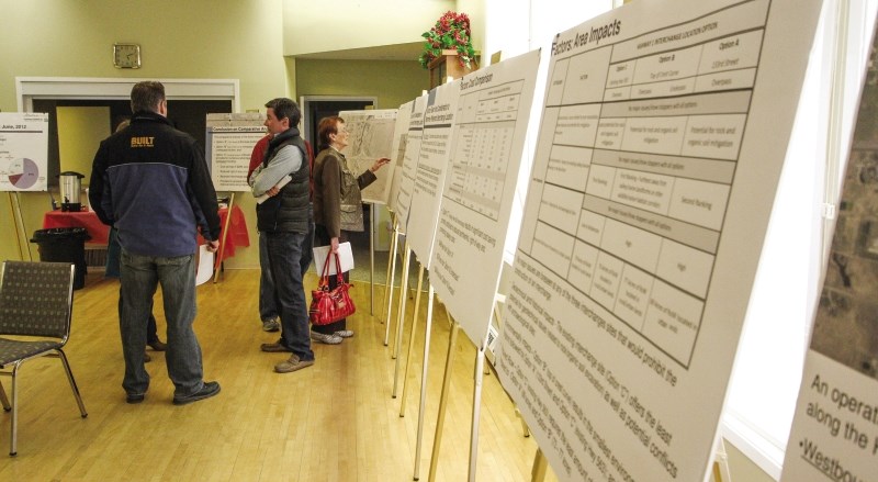 Area residents look over information during Feb. 13 open house to discuss future upgrades for sections of Highway 1 near Springbank.