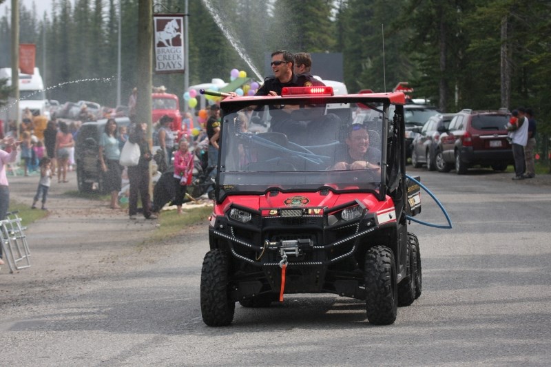 RMES members spray water on the crowd during the annual Bragg Creek Days parade on July 14, 2012.