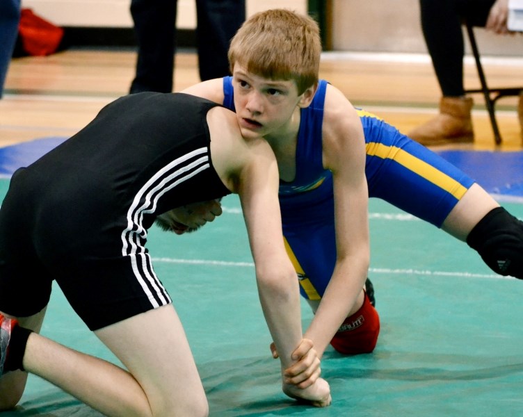 Cochrane Cowboys wrestler Connor McNeice (right) grapples with the opposition Feb. 16 en route to winning gold in his weight class at the Alberta Amateur Wrestling Junior