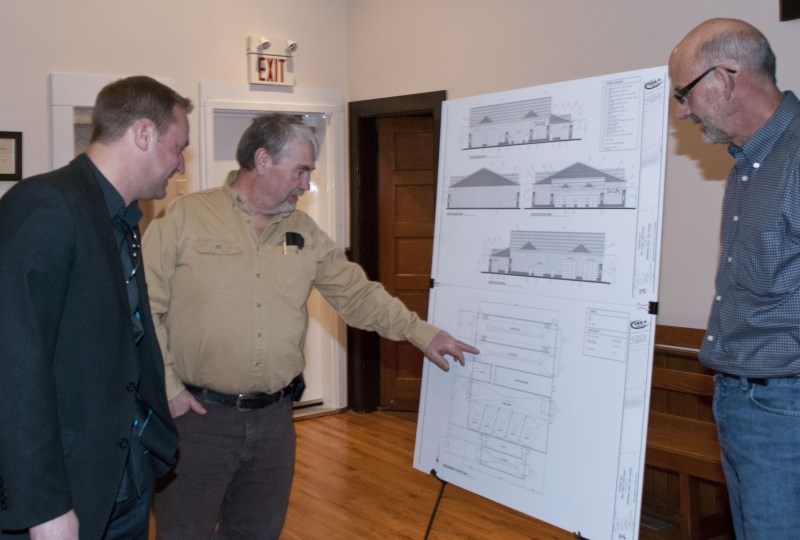 Spring Hill RV Park owner Sean Veraart (left) checks out the rough sketches of the proposed car and truck wash with equipment providers Gord Hunt (middle) of Rockyview