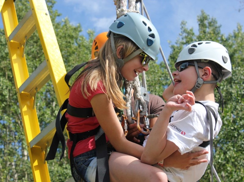 Derek (right) plays on the giant swing at Easter Seals Camp Horizon with his sister Jayden. Camp Horizon is the first — and only — Canadian recipient of support from the