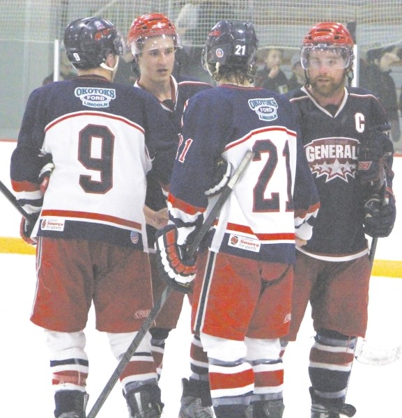 Cochrane Generals Nick Borody and Jay Labelle congratulate the Okotoks Bisons for a well-played series after Okotoks swept Cochrane from the Heritage Junior Hockey League