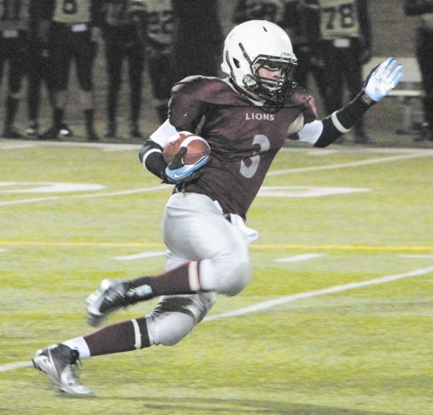 Cochrane Lions running back Scott Haigh heads for the open field in Calgary and Area Midget Football Association play against the Calgary Bulldogs April 5 at Calgary&#8217;s