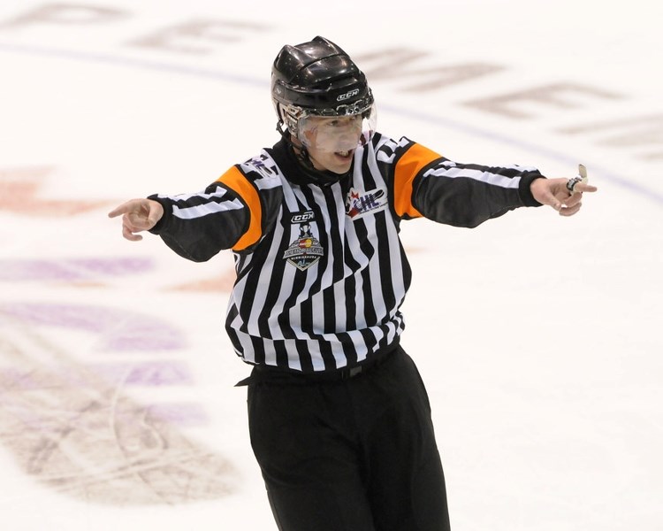 Cochrane&#8217;s Matt Kirk directs traffic while refereeing a tilt at the 2011 Memorial Cup Canadian major junior hockey Championship in Mississauga, Ont. The Mabbott &#038;