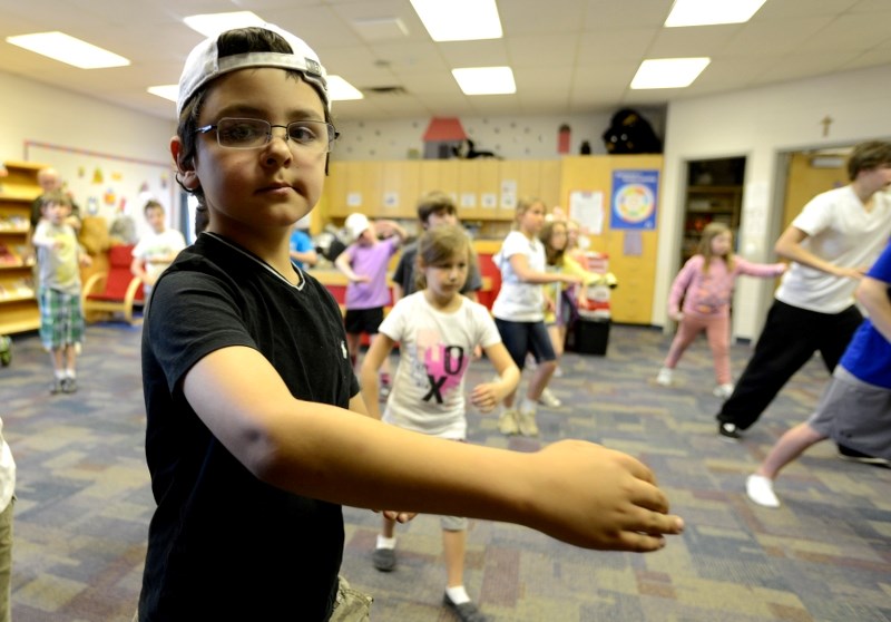 Nine-year-old Jacob Van Den Broek tries out some Tai Chi moves with his classmates as students learned a little bit more about having a healthy and active lifestyle May 9.
