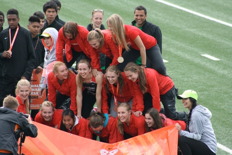 The Cochrane High School Cobras girls track team, minus their seniors who were taking part in graduation activities, mug for the cameras after a gripping performance at the