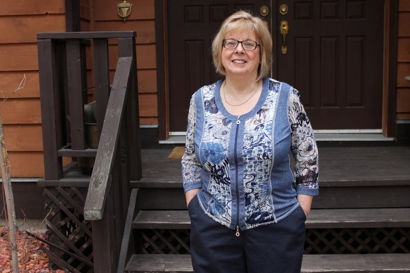 Linda Anderson stands in front of her house in Redwood Meadows. She recently attended the Redwood Meadows townsite annual general meeting and said the lease between the
