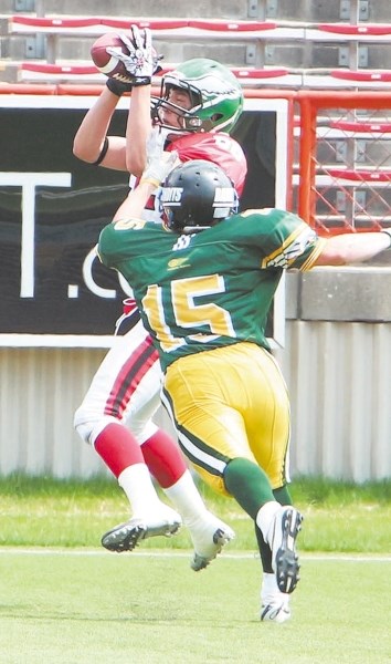 Springbank Phoenix receiver Kevin Natenstedt spears a touchdown pass for the South in front of North defender Chad Bowles during Football Alberta Senior Bowl all-star high