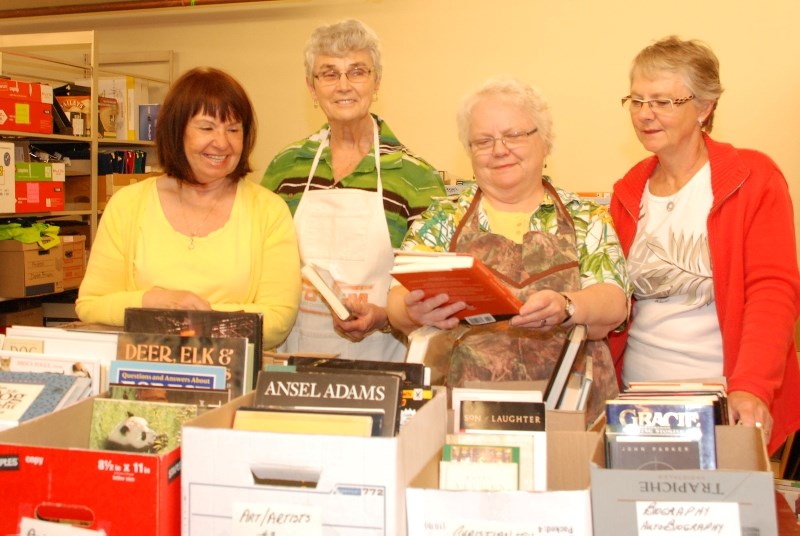 Friends of the Nan Boothby Memorial Library volunteers (from left) Diana Delver, Barb Archer, Anne Beck and Ann Beatty sort books in preparation for the Beyond Words sale,