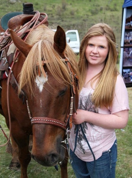 Fourteen-year-old Hannah Burrell of Didsbury, pictured with her dad&#8217;s roping horse, is the youngest pro barrel racer in Canada. She was at the 60th-annual Water Valley