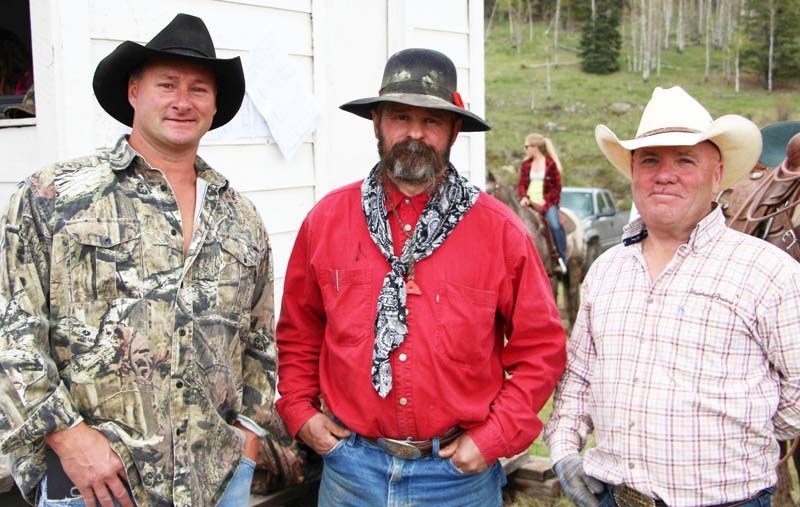 Wild-cow milkers (from left) Lynn Friesen, Bryn Thiessen and Bruce Burrell at 60th-annual Water Valley Stampede June 1. Burrell won the event.