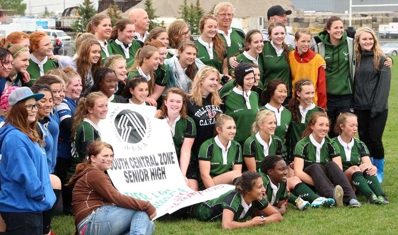 The Springbank Community High School senior girls rugby team displays their Alberta Schools Athletic Association South Central Zone Tier 2 championship banner. The school won 