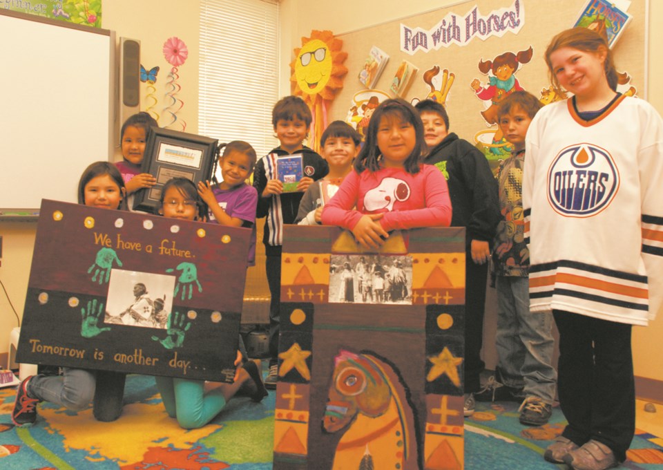 Some of the students of Glenbow Elementary School&#8217;s Roots and Wings program pose with their artwork. Their Warrior Paint project was awarded a BMO Financial Group