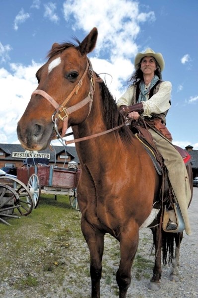 Rod Benett, a staff member at Wild Wild West Event Centre in Springbank, and his horse welcome guests to the facility&#8217;s new weekly farmers market, June 8.