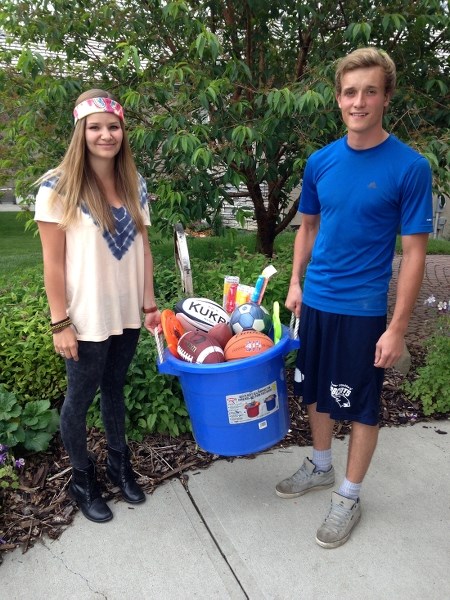 Bailey Serhyenko and Austin Lang with some of the sports gear they will be taking to Kenya later this month.