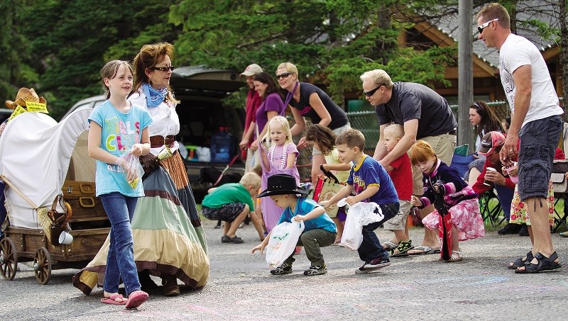 Kids rush to collect the candy tossed from parade entrants during Bragg Creek Days July 14, 2012. This year, Bragg Creek Days takes place July 19 to 21.