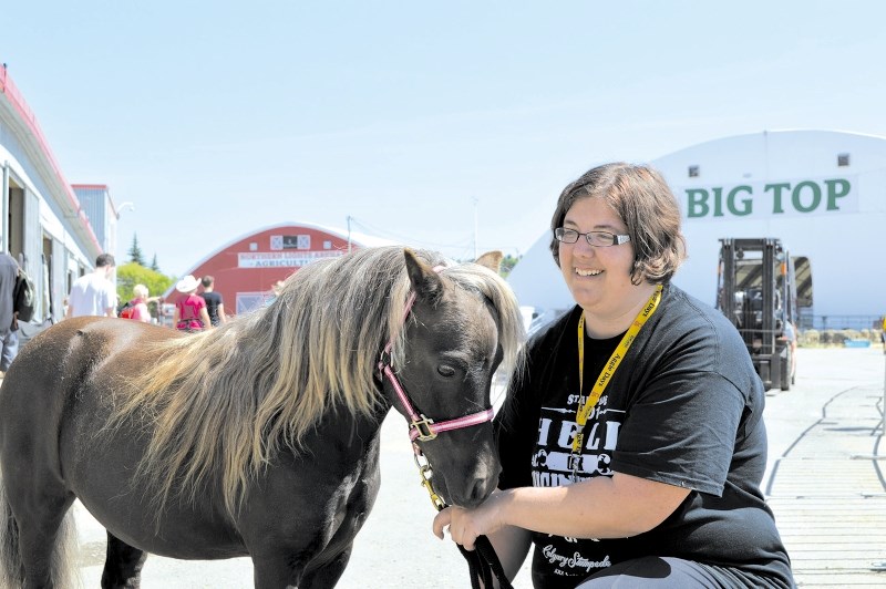 Kendra Gale and her miniature horse Hawk play around before the Canadian National Miniature Horse Show at the Calgary Stampede, July 9. Gale&#8217;s family owns a miniature